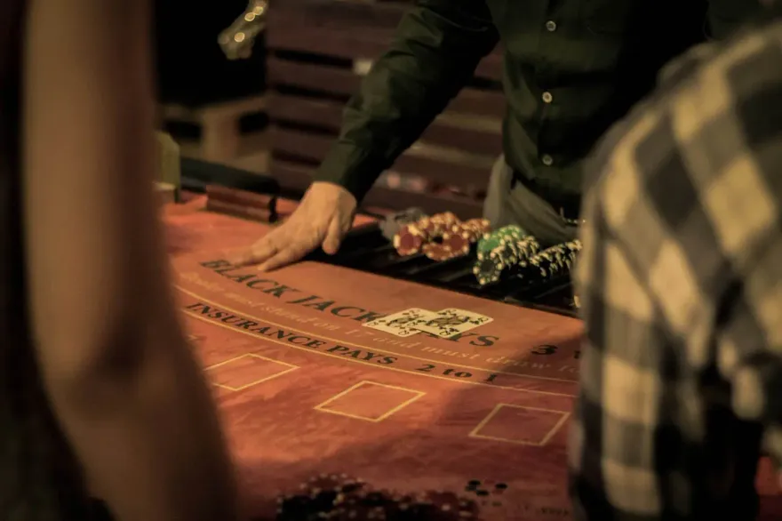 Blackjack felt layout with playing cards and casino chip stacks