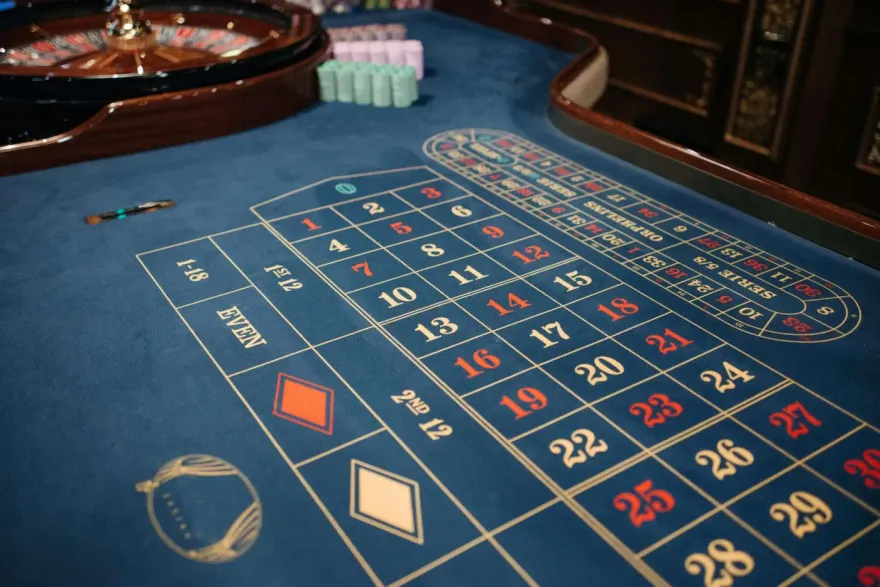 Close-up of a blue roulette betting table layout and wheel
