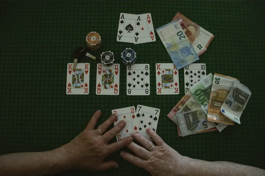 Poker hand with playing cards, chips and euro banknotes