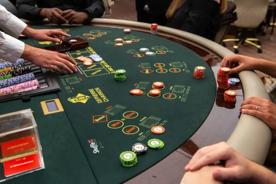 Dealer and players with poker chips at a live casino table