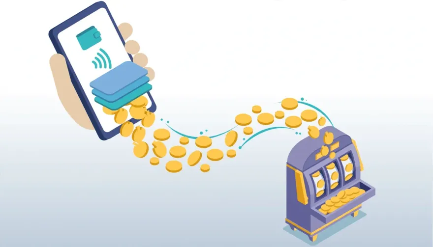 Hand holding a smartphone with coins flowing toward a slot machine