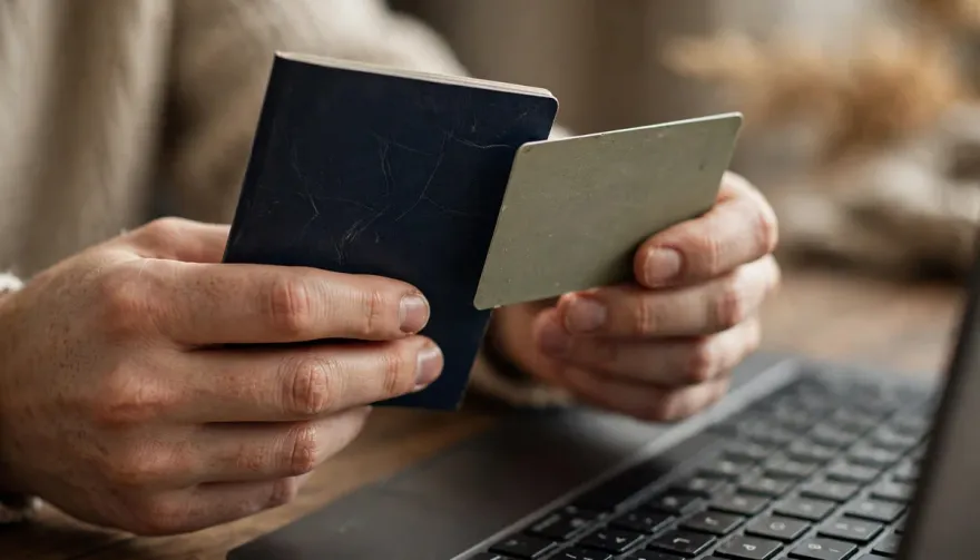 Player holding ID documents and a bank card for withdrawal verification