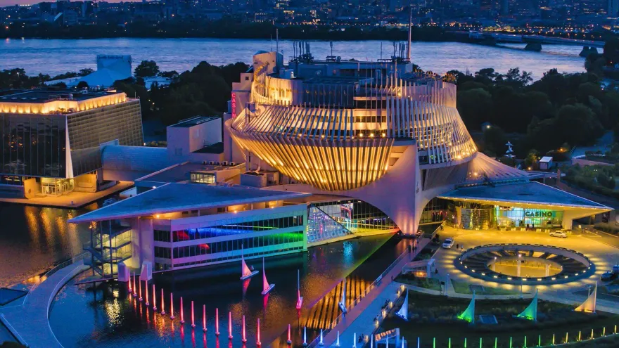 Aerial night view of the illuminated Casino de Montréal building beside the river