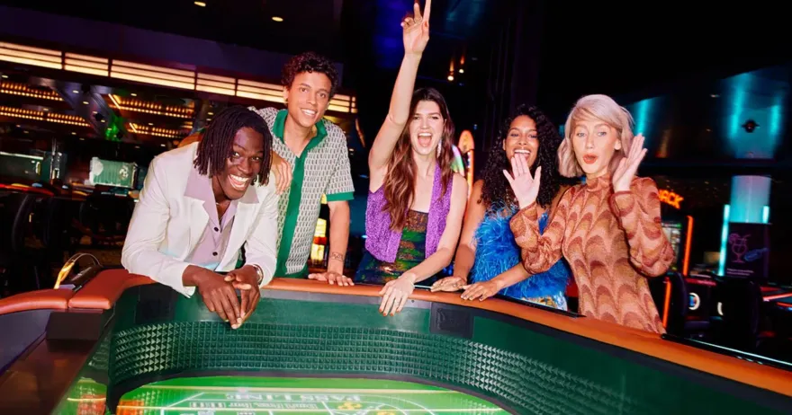 Group of guests celebrating a win at a Casino de Montréal table game
