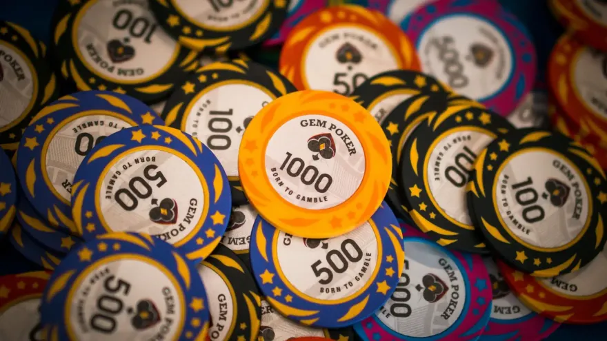Stacks of colorful poker chips in various denominations used for casino table games