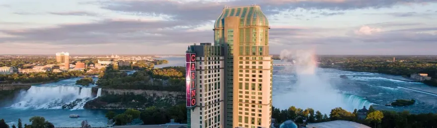 Aerial dusk view of Niagara Falls with the Fallsview Casino Resort tower overlooking the water
